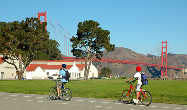 Two people cycling in the Presidio near the Golden Gate Bridge in San Francisco